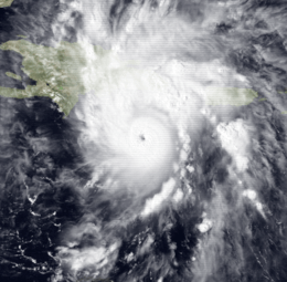Satellite image of a mature hurricane. The storm features a small, but prominent eye and the whole system covers most of the eastern Caribbean Sea. Haiti can be seen along the edge of a feeder band and eastern Cuba is also visible on the left side of the image.
