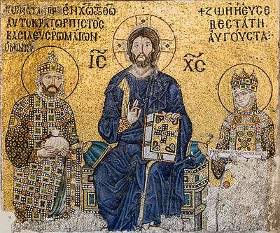 A mosaic with a background of gold depicts a seated Christ Pantocrator. A woman stands to his left and her husband stands to his right.