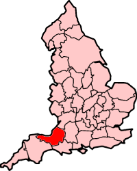 Map of England in pink with the area occupied by Somerset shaded in red