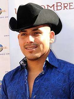 A man with a black cowboy hat on