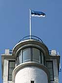 Flag of Estonia on top of Suur Munamagi watch tower, the highest point in Estonia and Baltic states, at 318m above sea level
