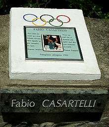 A plaque honoring Casartelli with a picture of him in the center.
