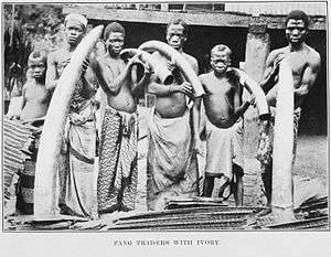 Group of men holding elephant tusks