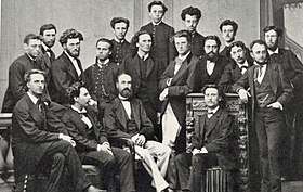A group of 18 men in 19th century dress