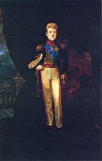 A full-length painted portrait of a tall youth standing before a draped throne and dressed in white trousers and an elaborate military-style tunic bedecked with medals