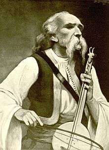 Moustachioed man playing a one-stringed instrument