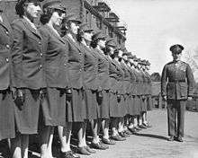 A group of women officer candidates brought to attention by a male instructor during the Second World War