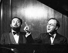 Photo of Flanders and Swann singing at the piano