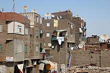 Tenements with satellite dishes and debris