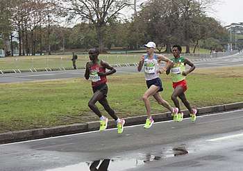 Kipchoge (shown left) en route to his Olympic gold medal, 40 minutes until the finish. Rupp (middle) and Talisa (right) following him.