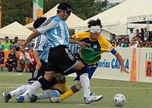 two Argentinian players and one from Brazil running after the ball or falling down
