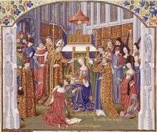 A crowned woman who sits on a throne puts a crown on the head of a man who kneels before her; they are surrounded by two bishops, other clerics and secular lords and ladies