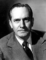 Black-and-white photo of Fredric March in 1940—a middle-aged white man with straight hair, a furrowed brow, and a broad forehead, wearing a suit.