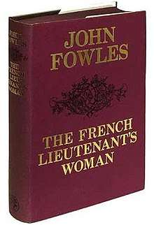 A red, first-edition hardback cover of The French Lieutenant's Woman with gold embossed title and author's name on the front cover and a black printed bramble of thorns separating the two.