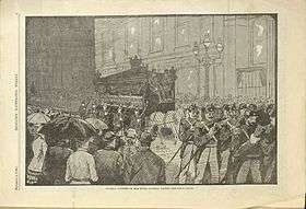 An etching of the scene of Miss Fanny Parnell’s funeral parade found in the periodical.  The scene shows the mourning carriage with mutes sitting atop of it walking behind soldiers with a crowd watching.
