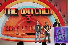 Three men onstage at Game of the Year awards