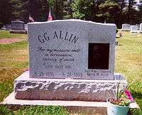 A marble gravestone engraved "GG Allin: For my mission ends in termination, vicinity of death. Live fast die; 8-29-1956&nbsp;– 6-28-1993"