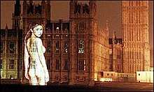 Colour photograph of a naked image of Gail Porter projected onto the Palace of Westminster in 1999