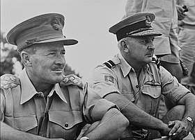 Two uniformed men in peaked caps