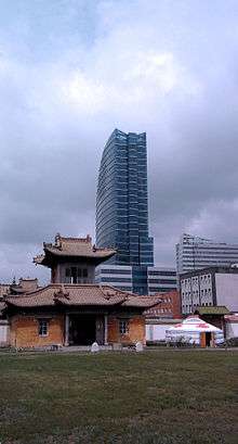 Three types of buildings against a cloudy sky