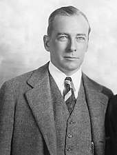 Black-and-white photo of a man wearing a three-piece suit.