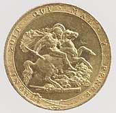 A gold coin showing as its central element a naked man on a horse attacking a dragon using a broken spear