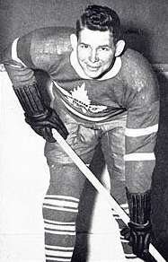 Photo of George Parsons in a Toronto Maple Leafs uniform, posing with a hockey stick