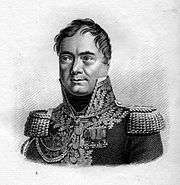 Black and white print shows a clean-shaven man with a cleft chin and widely-spaced eyes. He wears a dark French military uniform of a general of the Napoleonic era, with a high collar, epaulettes and lots of lace on the collar and front.