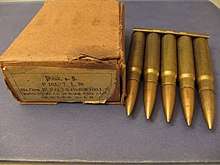 five cartridges held together at their bases by a strip of metal