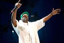 Ghostface Killah performing on stage holding a microphone.