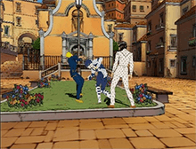 A screenshot showing two young men in a town environment, facing off in a battle. The one on the right, Bucciarati, has summoned a spirit-like, humanoid "Stand", which he uses to attack the man on the left, Giorno.