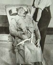 Photograph of the corpse of Glyndwr Michael, strapped to a stretcher in Hackney mortuary