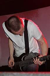 Justin Broadrick playing a seven-string guitar with Godflesh