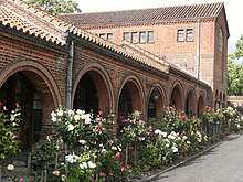 A brick cloister, built in a modified Lombard-Romanesque style
