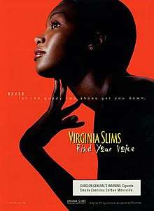 Ad showing a young, carefully made-up, dark-skinned model leaning forwards, looking upwards and delicately touching her extended throat; she is nearly exactly in profile, in silhouette on a bright red ground, with the light catching only her face, throat, fingers, and a single clear stone in her earlobe. Her hair seems very closely-cropped. A subtle white overlaid text reads "NEVER let the goody two shoes get you down" and, in a much larger shadowed yellow hand-written-looking font, "Find your voice"