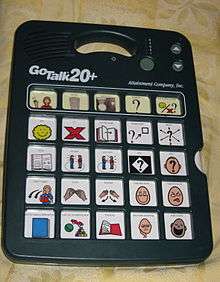 an electronic device with speakers and a slot to insert cards that have new sets of symbols on them. The current card has 25 symbols that relate to book reading