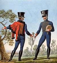 Color print shows two men dressed in hussar-style dark blue jackets and breeches with shakos. The jackets have yellow braid. One of the men has a red pelisse with black fur trim hanging over his shoulder.
