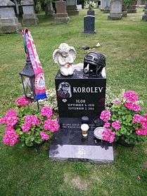 Gravestone of Igor Korolev in Mount Pleasant cemetery, Toronto, decorated with flowers and memorabilia