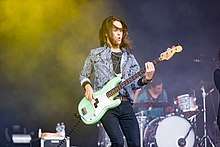 Sam Kiszka playing bass guitar during a live performance in Germany (June 2018).