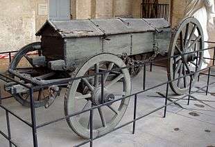 Photo shows an old wagon with the wheels on one axle larger than the other axle.