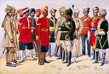 A painted illustration showing a group of men wearing various 19th Century military uniforms&nbsp;&ndash;&#32;some wearing sand-coloured tunics, some red and some black. All of the men are wearing turbans of various colours.