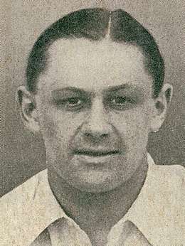 Headshot of a man in a white shirt