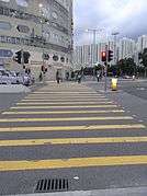 Crosswalk with simple yellow parallel lines in Hong Kong