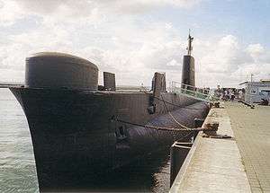 A submarine tied to a dock.