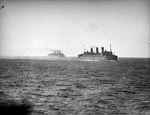 Black and white photo of two passenger ships sailing near each other