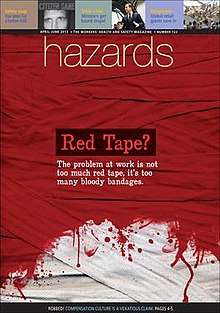 Interwoven strips of cloth mostly stained red, fading to white near the foot of the image. The caption says "Red tape? The problem at work is not too much red tape, it's too many bloody bandages".