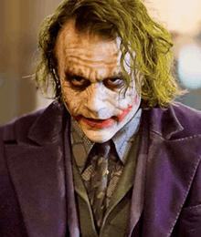 Close-up of Heath Ledger as the Joker in The Dark Knight, showcasing his makeup and Glasgow smile.