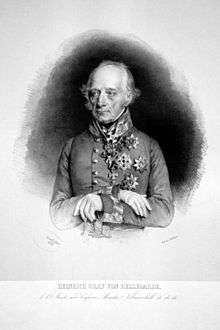 Engraved reproduction of a formal portrait of Bellegarde. He is an elderly man with wispy grey hair and long eyebrows, bony features and an imperious expression. He wears military uniform and numerous decorations. His gloved hands are folded over the hilt of a sword.