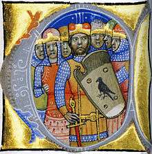 Seven warriors, one of them wearing a coat-of-arms which depicts a predatory bird