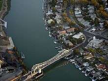 Aerial view of a bascule bridge (drawbridge) spanning the estuary separating Oakland from Alameda.